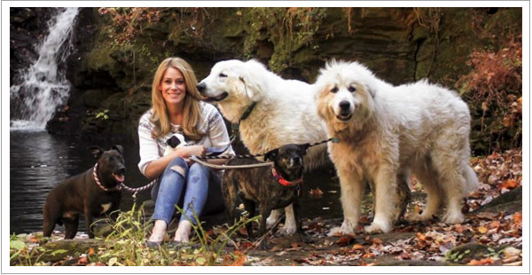 Owner of Serenity Dog Retreat, Beth Ramsey in her college years sitting with her five dogs